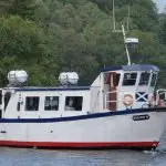 Hunters Executive Coaches vehicle at Loch Katrine in the Trossachs